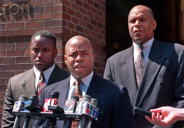 New York City Police Lt. Eric Adams, center, co-founder of the group "100 Blacks in Law Enforcement," speaks during a news conference as Officer Eric Josey, left, and Sgt. Noel Leader look on Wednesday, Aug. 18, 1999, in New York. The city's police union should not be supporting the former officer convicted in the Abner Louima torture trial, according to the black law enforcement group. (AP Photo/Marty Lederhandler)