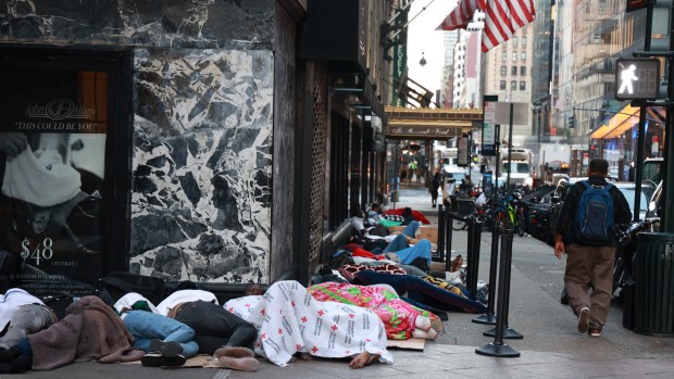Migrants are seen sleeping outside of the Roosevelt Hotel in Midtown Manhattan on July 31, 2023.