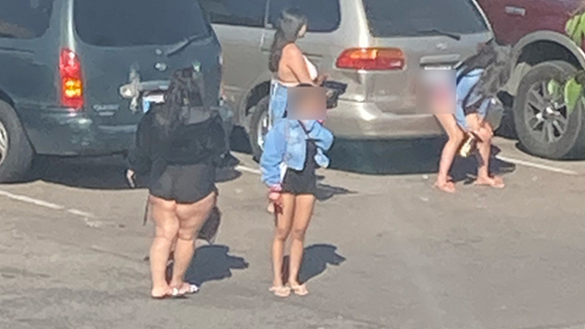 Women standing outside cars in San Diego
