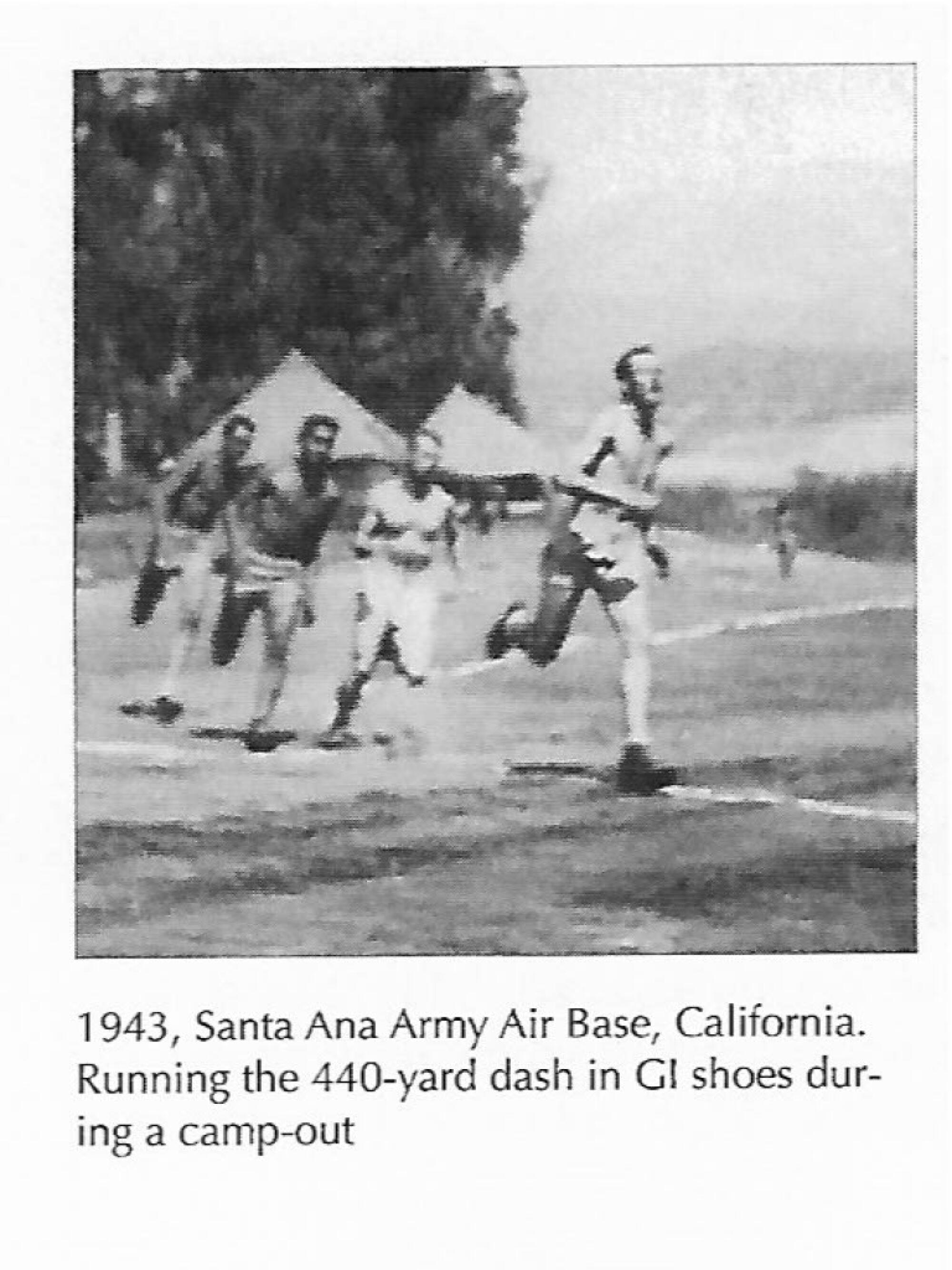 A black-and-white photo of four people running in a field 