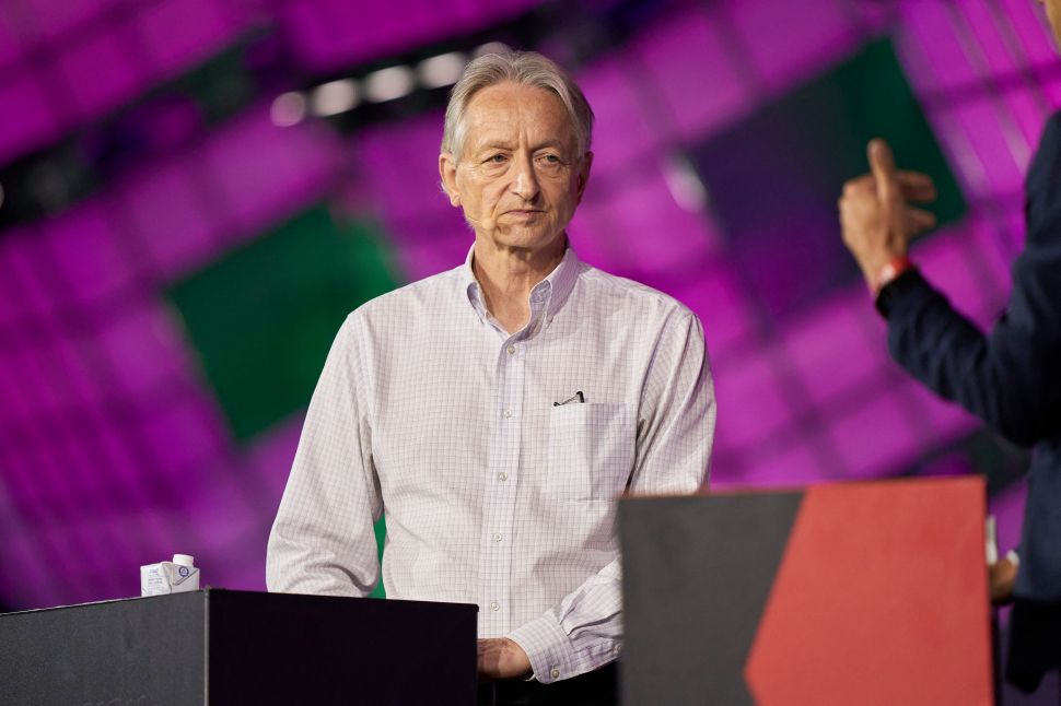 Man in white button up stands at podium on stage