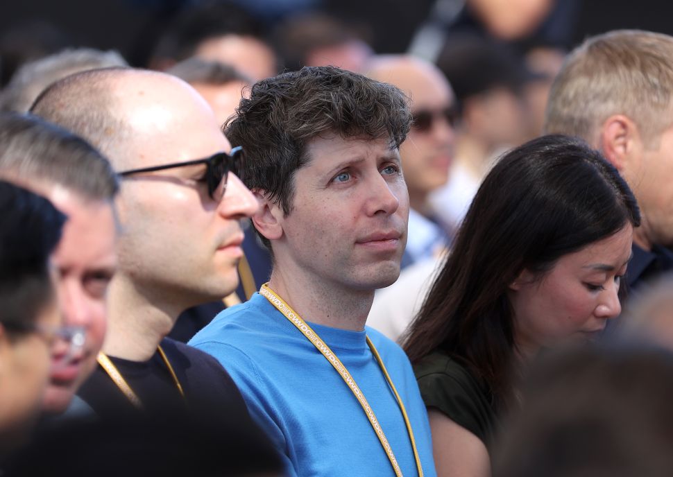 Man in blue tshirt stands in crowd