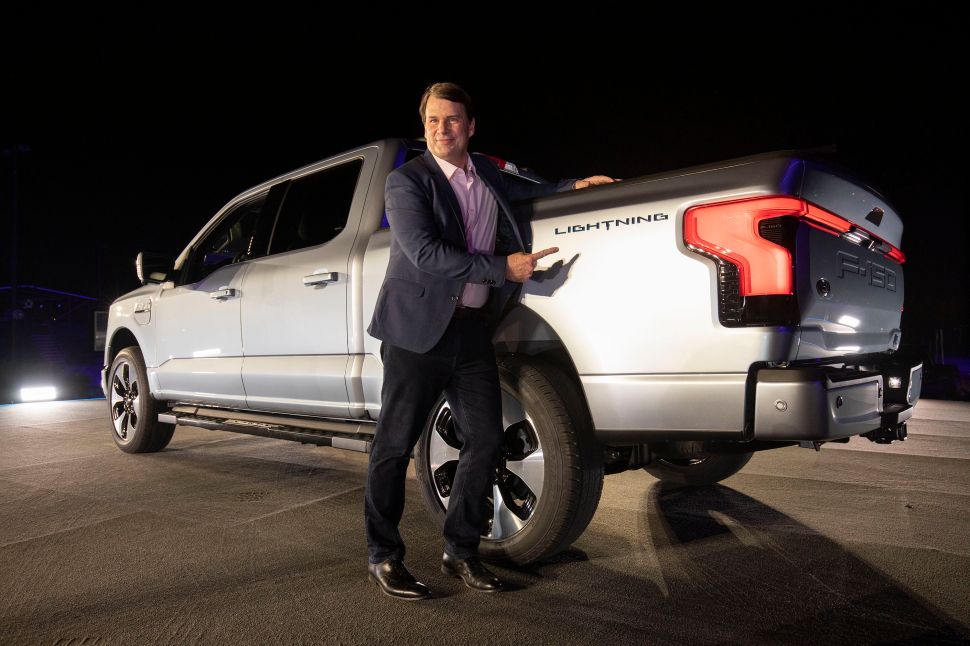 Man stands in front of large truck 