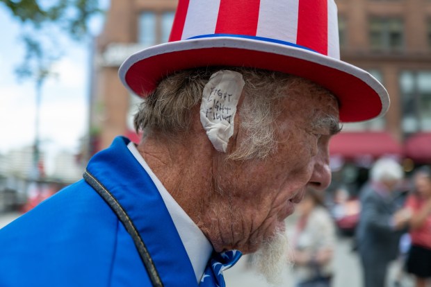 A Donald Trump supporter and performer places a bandage over his ear in reference to Trump's wound at the Republican National Convention (RNC) on the third day of the convention on July 17, 2024 in Milwaukee, Wisconsin. (Spencer Platt/Getty Images)